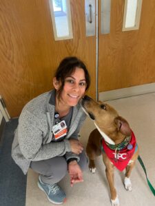 Chloe the therapy dog with an HCA Florida Healthcare Employee at the Destin, FL rehabilitation center