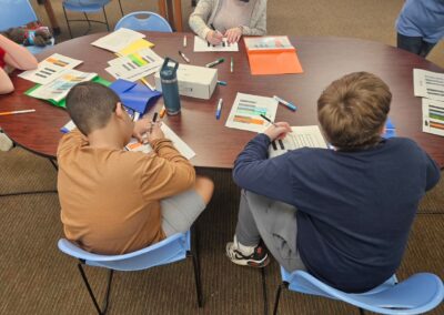 photograph of students coloring in sheets of keyboard keys